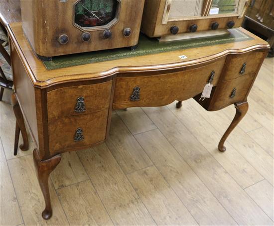 A figured walnut writing desk, fitted green leather skiver and three drawers, W.116cm